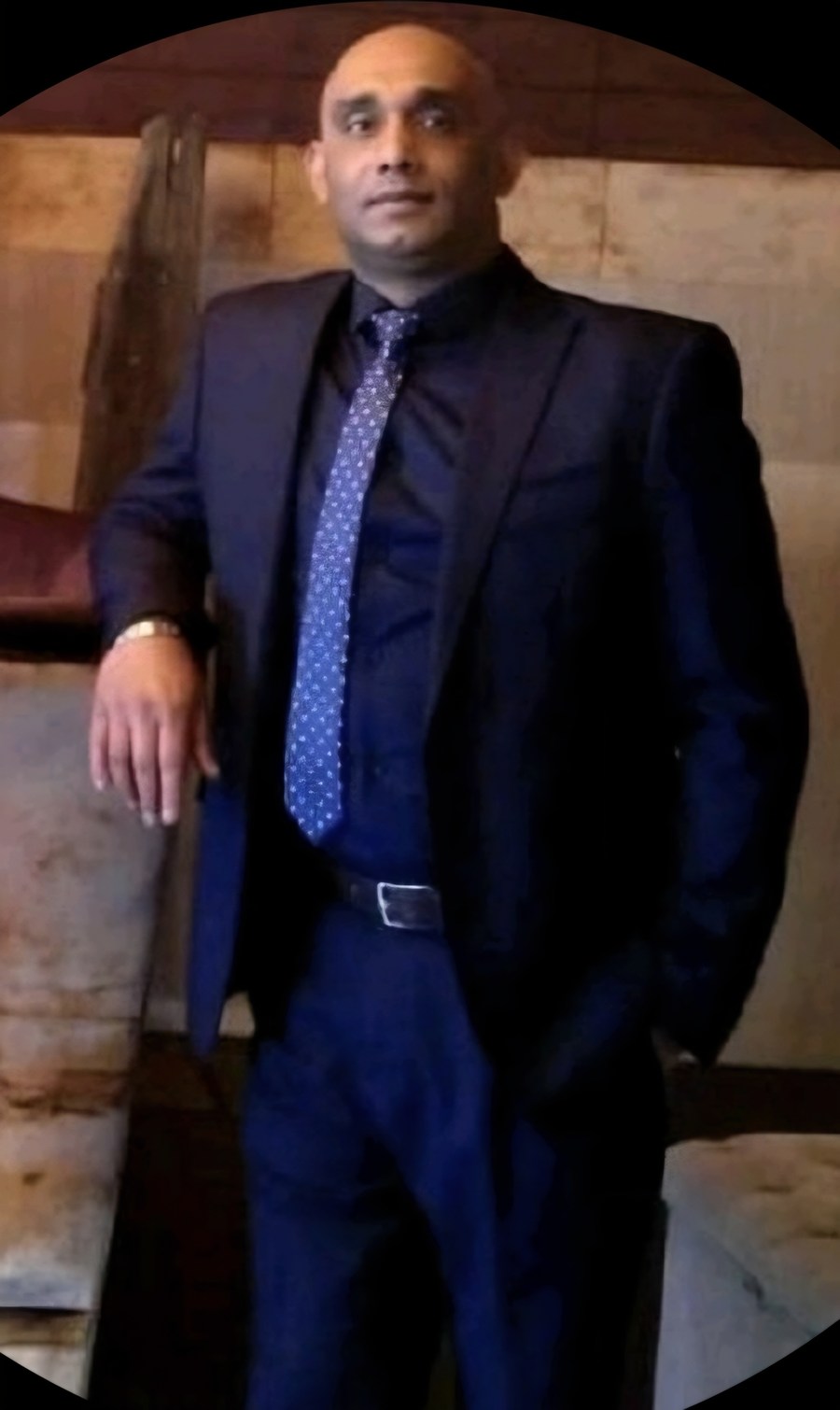 Siven Naidoo, founder of Invisible Consulting, wearing a blue suit